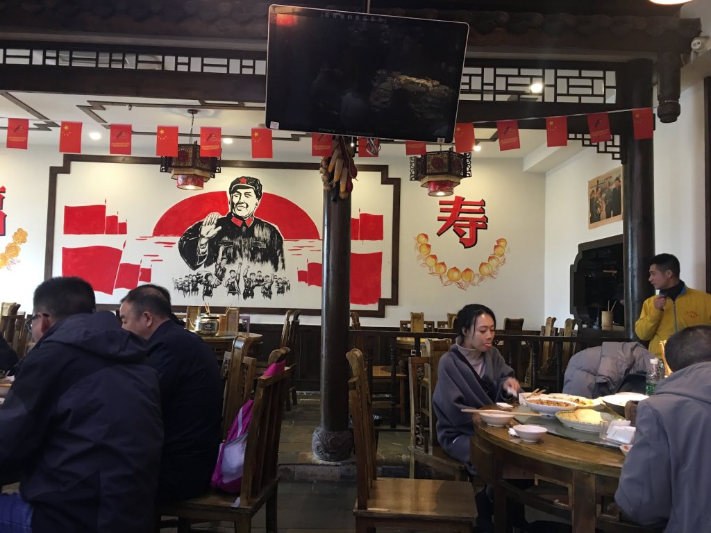 Photo inside a Chinese restaurant with people eating.